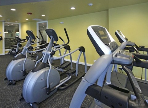 a gym with several pieces of exercise equipment